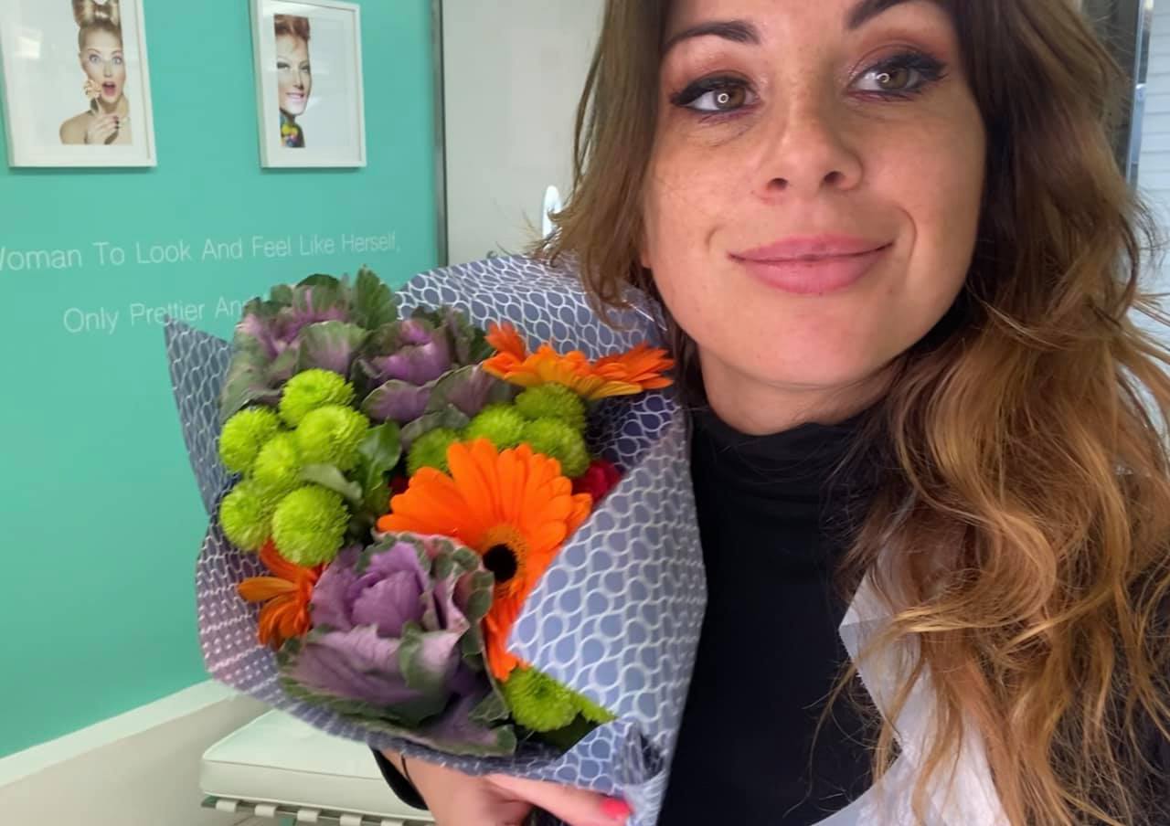 Katy holding Breda's gift of flowers