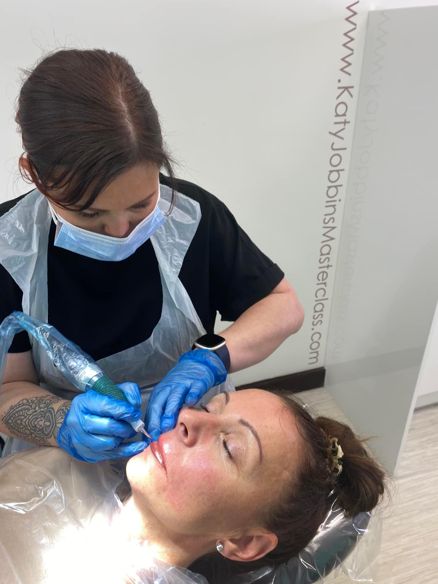 Lori-ann tattooing a clients lips