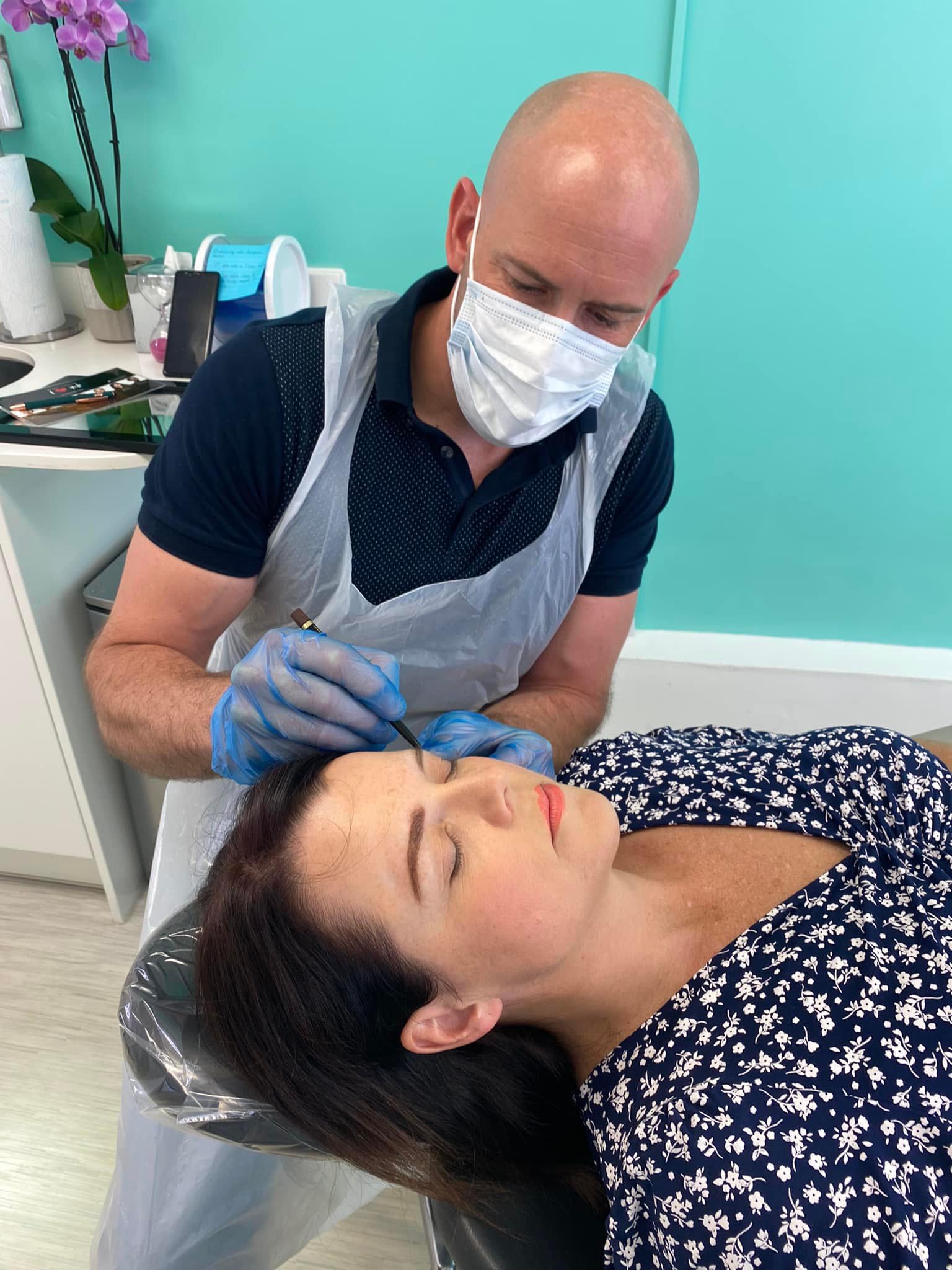 Lee doing permanent makeup on his second client in training