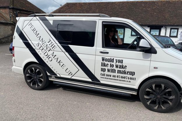 Lisa driving her van advertising her business