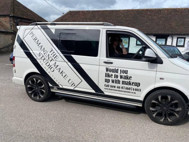 Lisa driving her van advertising her business Lisa driving her van advertising her business