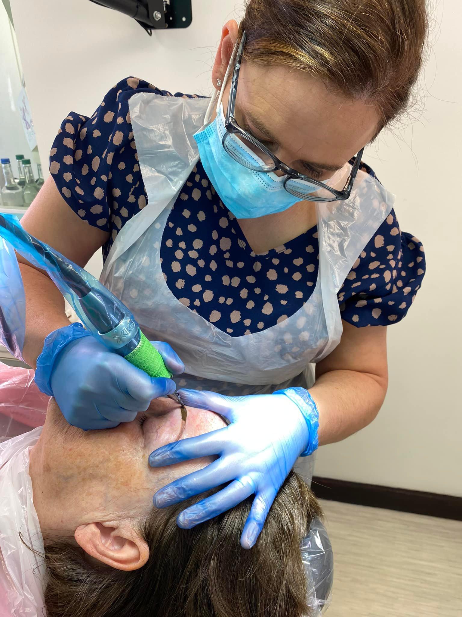 Alison performing permanent makeup on her client during training