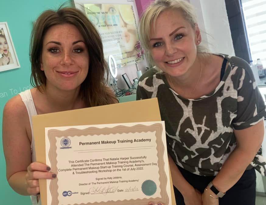 Natalie being presented with her permanent makeup artist training certificate by Katy Jobbins
