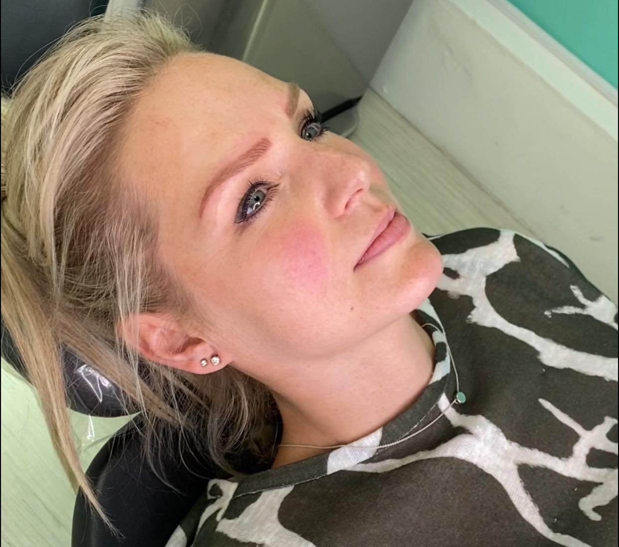 Natalie having her own eyebrows tattooed by Katy Jobbins