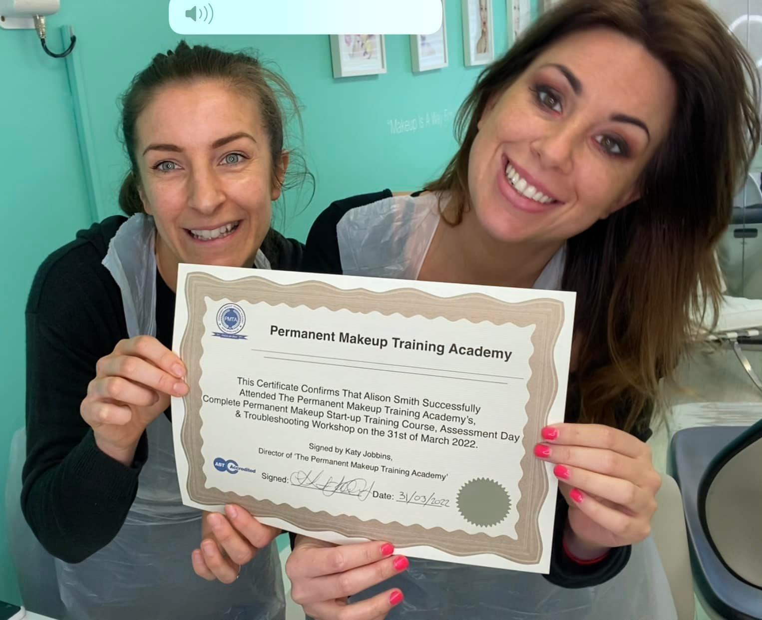 Alison receiving her permanent makeup training certificate from Head Trainer Katy Jobbins
