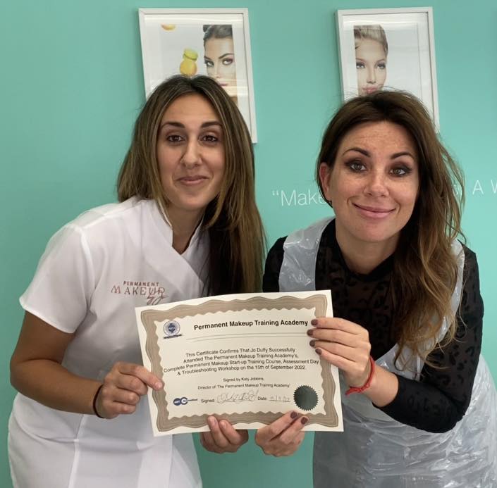 Jo receiving her certificate for completing her Permanent Makeup Training with Katy Jobbins