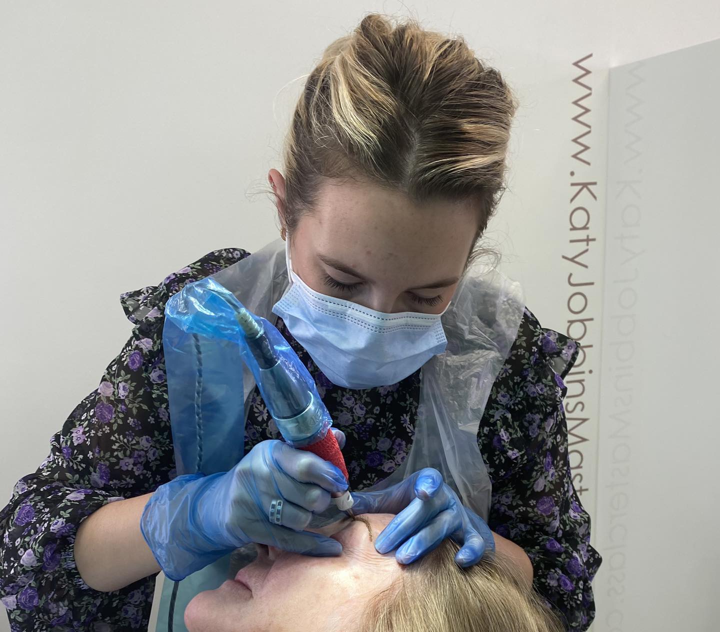 Aimee working on a permanent makeup client