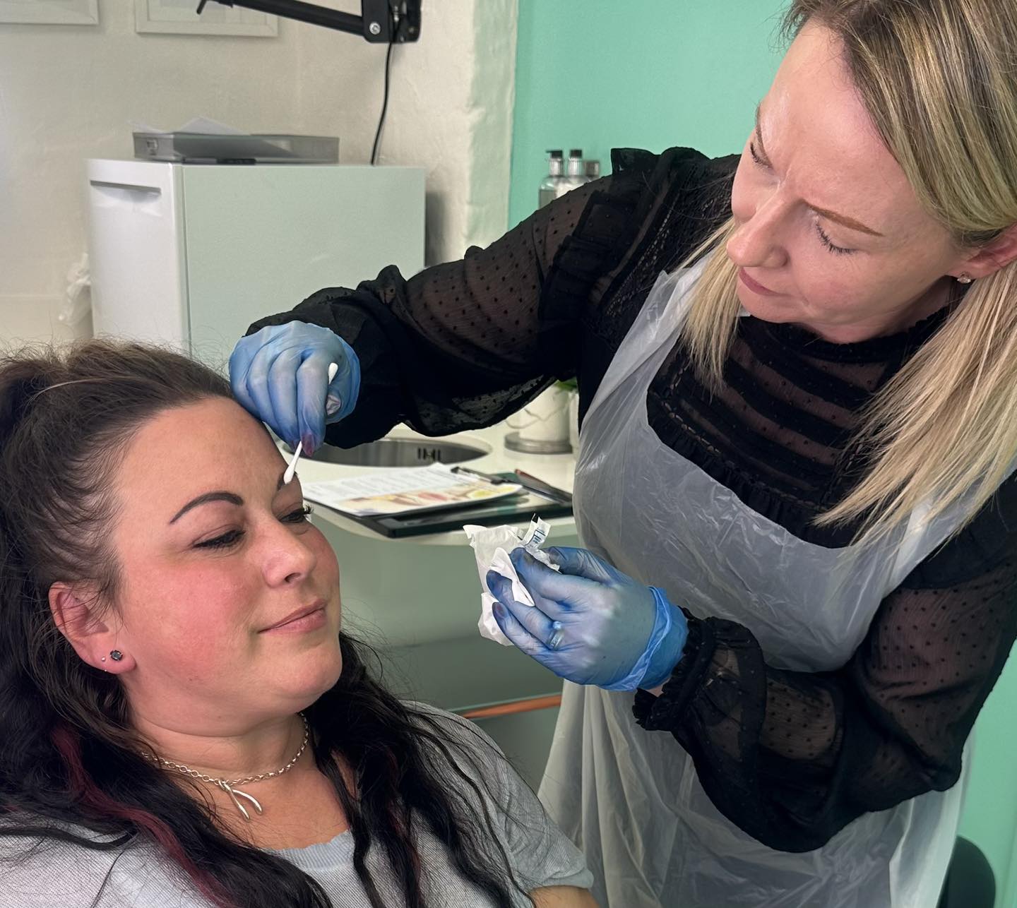 Katie preparing her client for permanent makeup