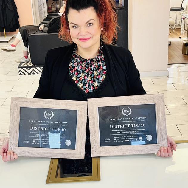 Nadine Hill with award certificates