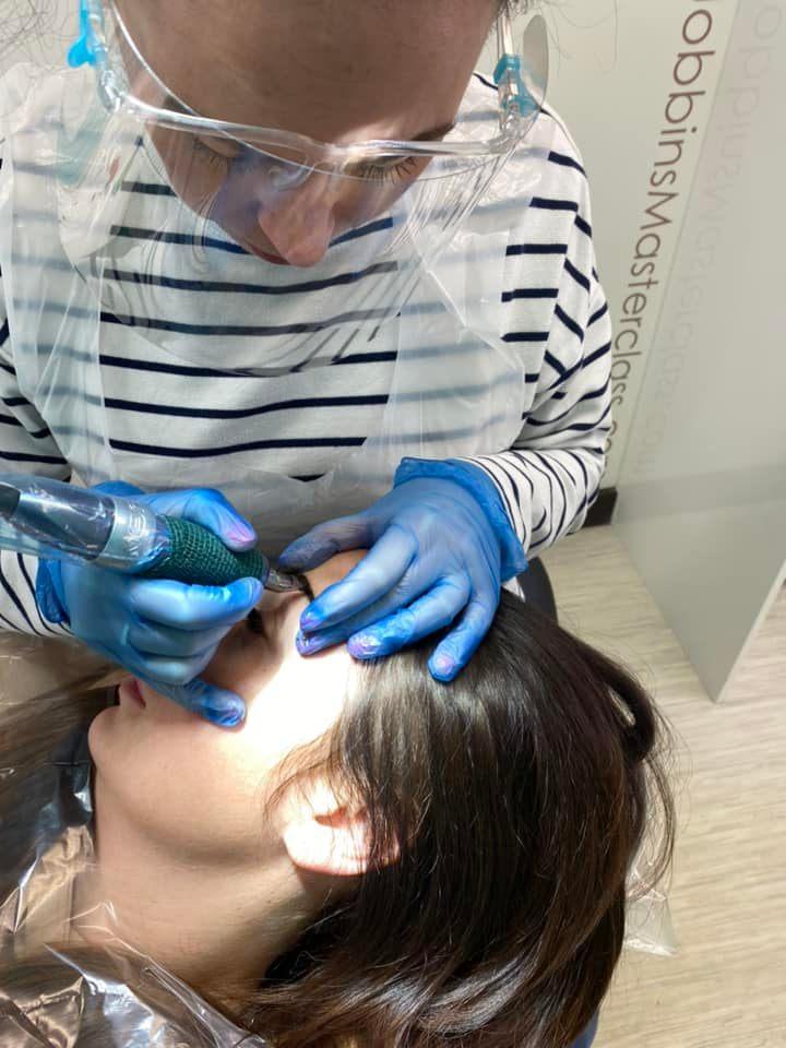 Sara working on another client's brows