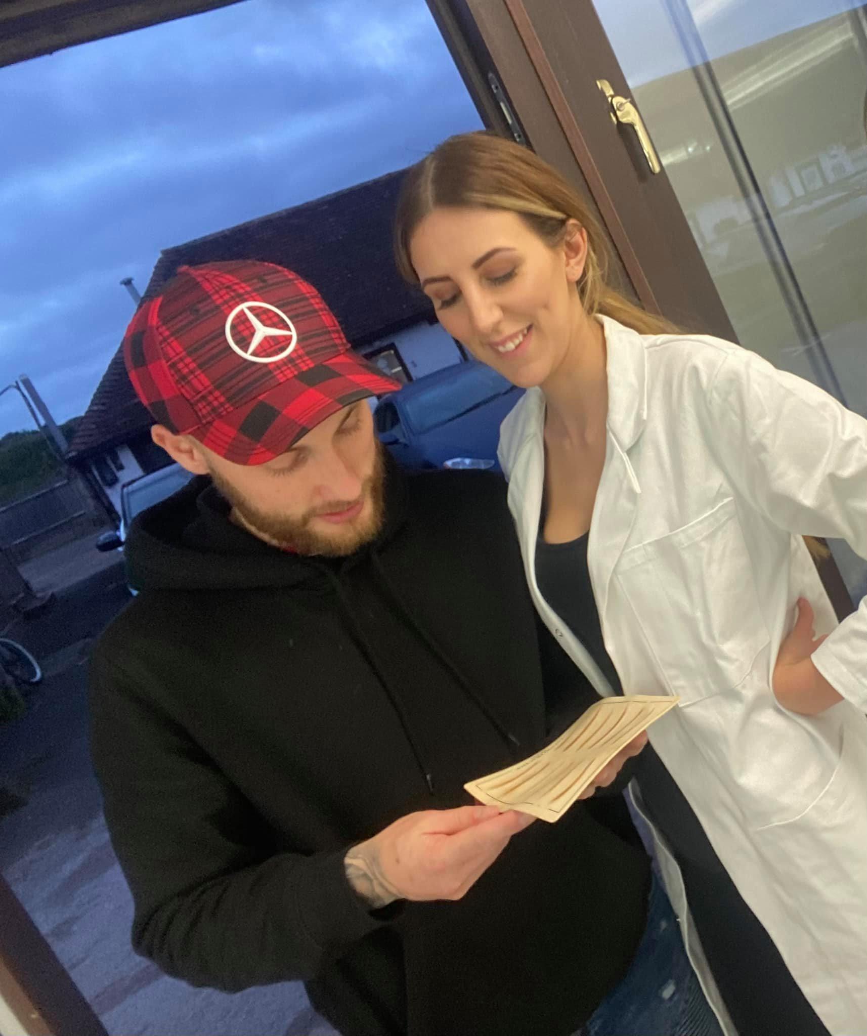 Jenna with her husband as he looks at her impressive results