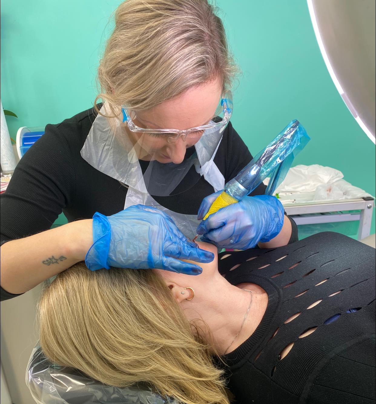 Kelly completing her clients lips