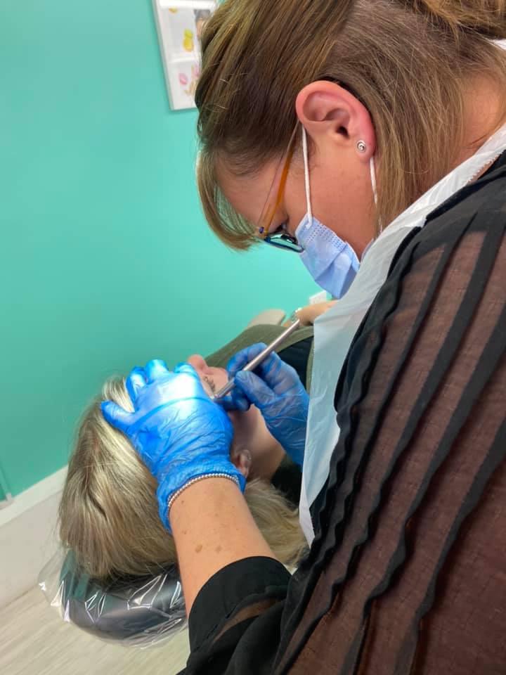 Vicki microblading a client's brows