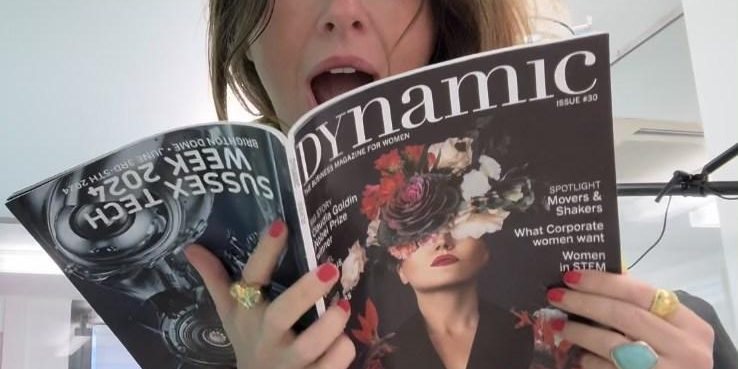 Katy reading an article about herself in Katy in Dynamic Business Magazine for Women