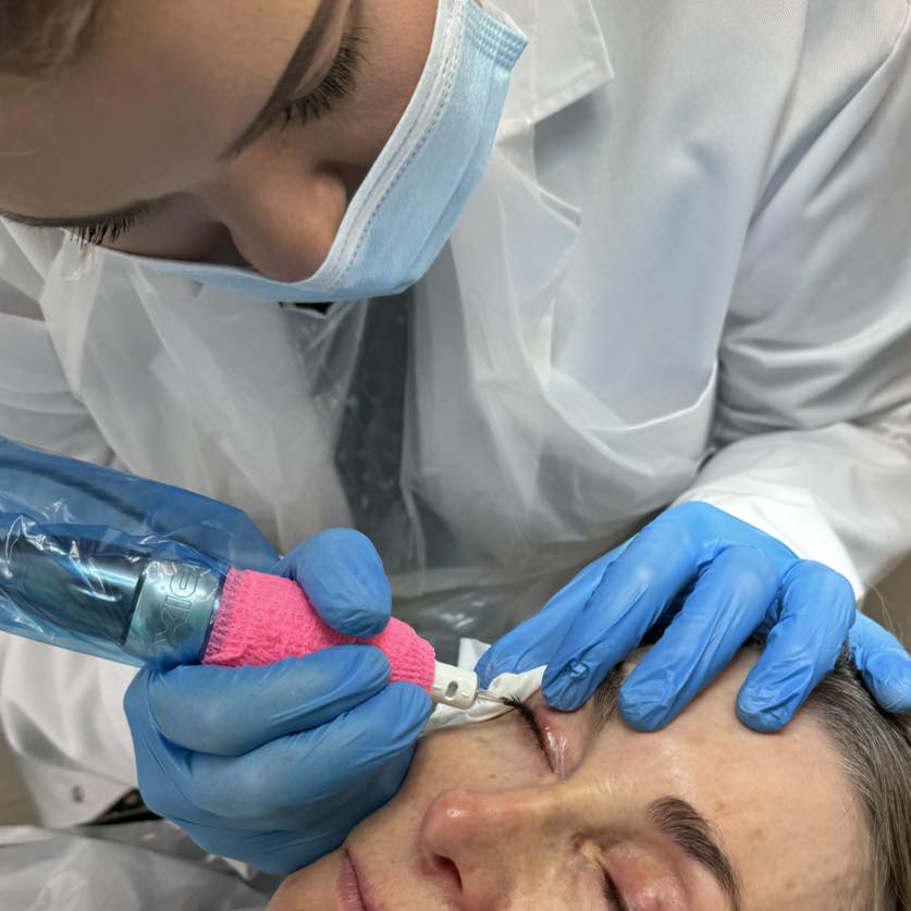 Lucy working on a client's permanent eyeliner procedure